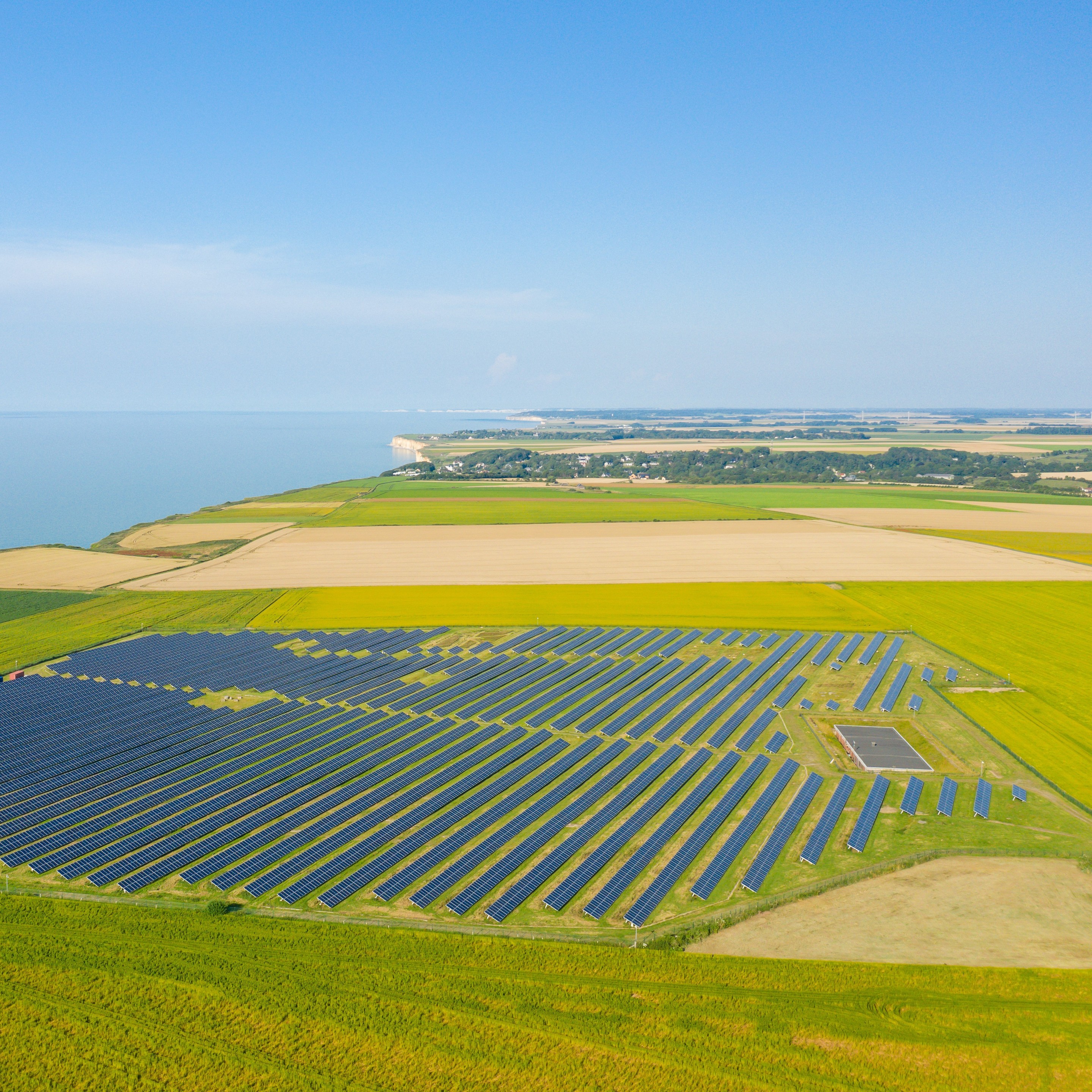 A photo of solar panels in the middle of the flax fields towards Veules les Roses in Europe, France.