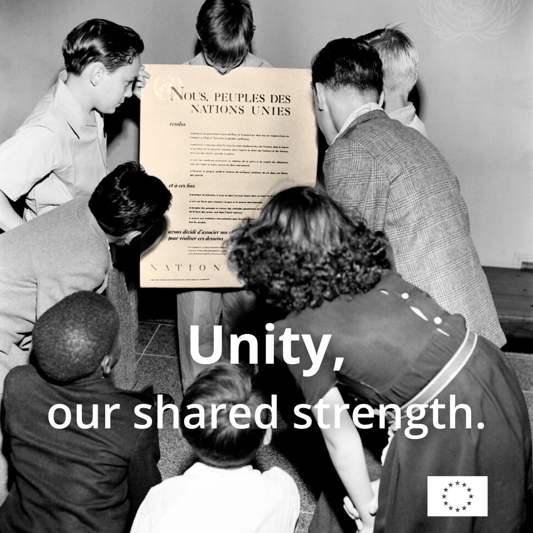 Vintage black and white photo of seven children gathered tightly, leaning in to read a large poster.  
The visible text on the poster, written in French, includes the line: "NOUS, PEUPLES DES NATIONS UNIES" (We, the Peoples of the United Nations). Overlaid in white across the bottom half of the image is the text: "Unity, our shared strength."  
The European Union logo is in the bottom right corner.
